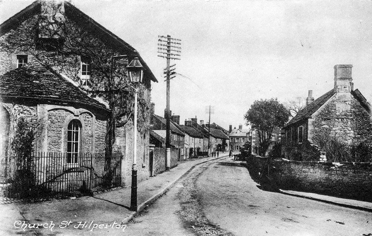 A printed view along Church Street with telegraph poles and a stone building close on the left.