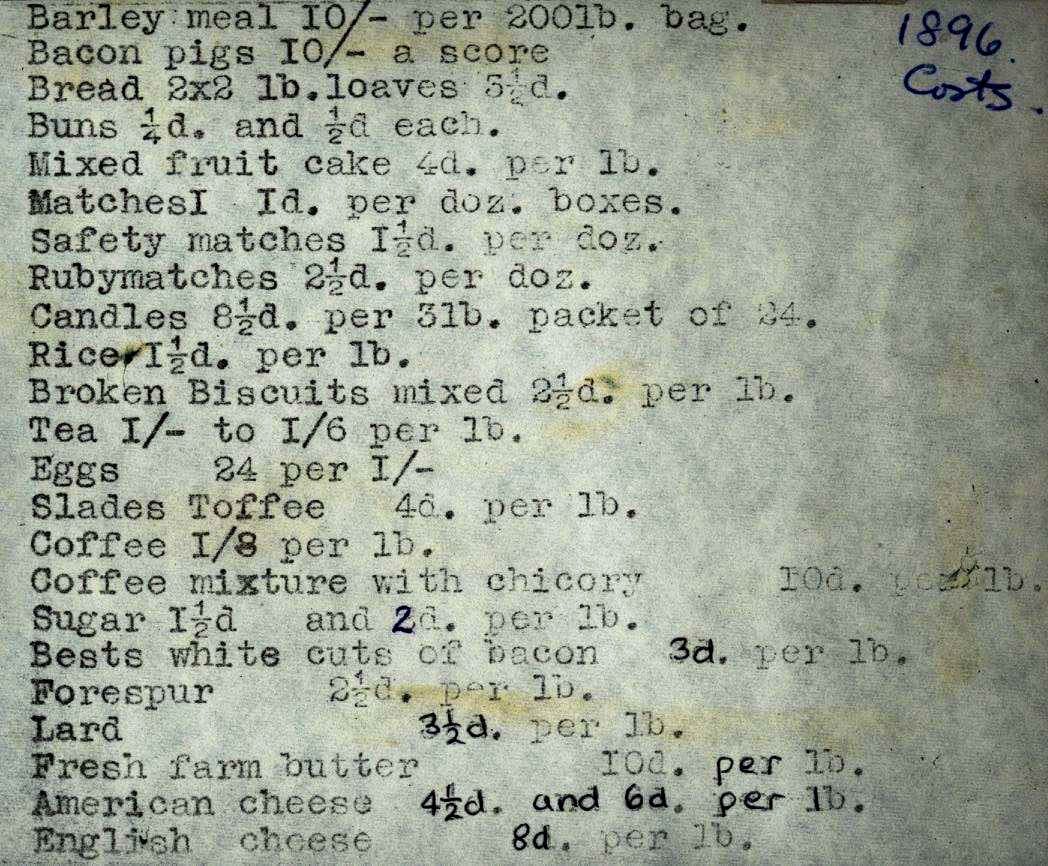 A typed list of goods and prices — barley meal, bacon pigs, mixed fruit cake, safety matches, coffee mixture with chicory — annotated '1896' in pencil.