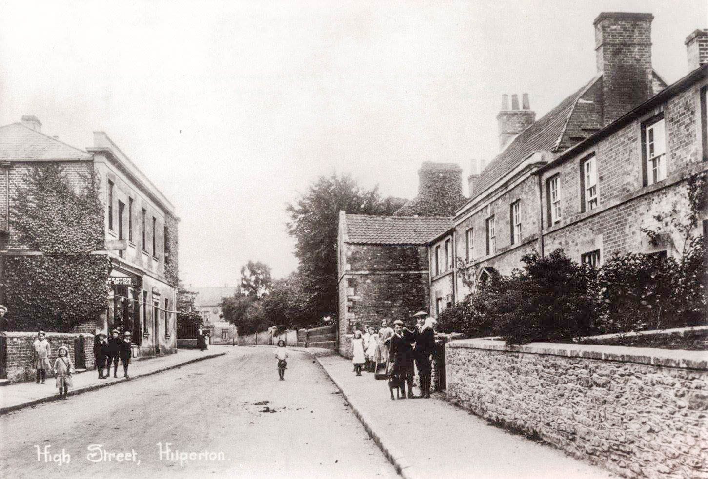 A wide view of the terrace running away from the camera, with figures standing at intervals along the pavement.